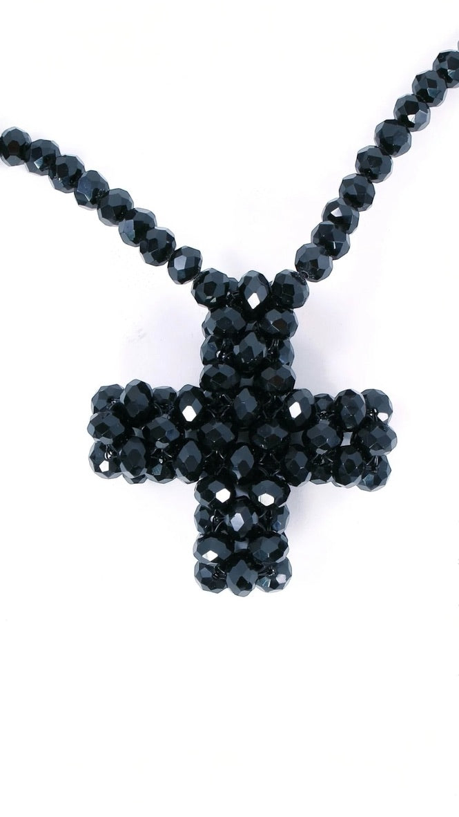 Elegante lange schwarze Perlenkette mit funkelndem Kreuzanhänger – ein stilvolles Accessoire für jeden Look.